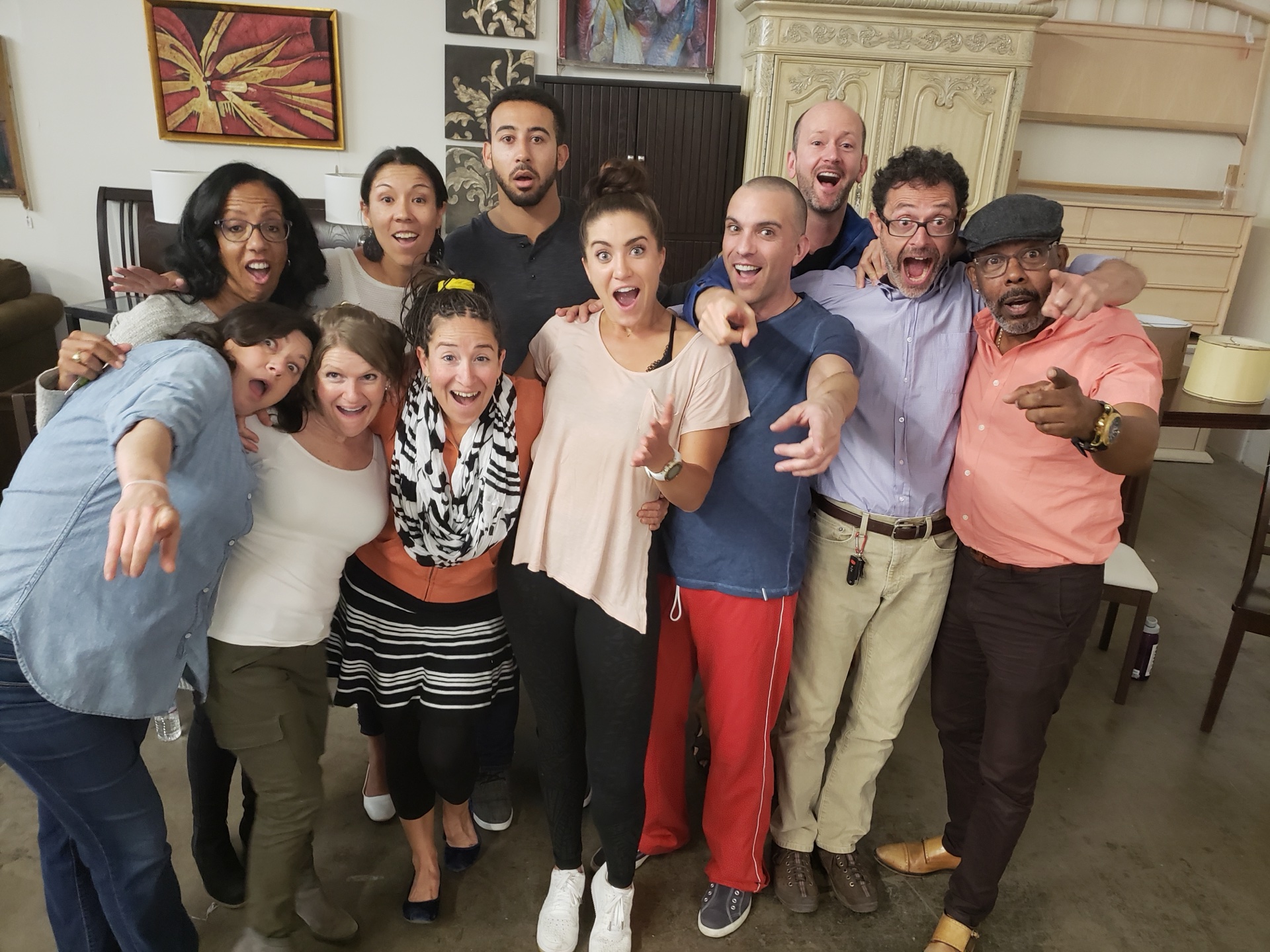 A diverse group of workshop participants laughing together