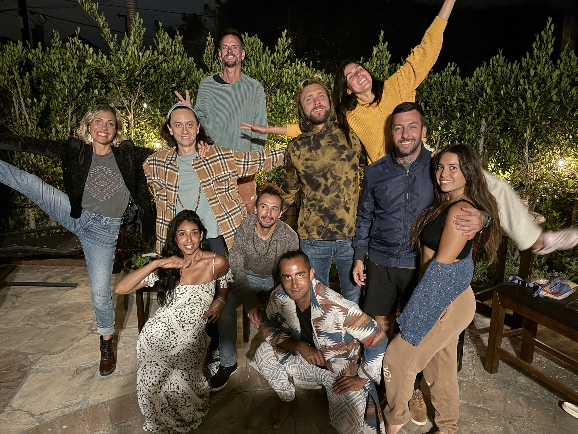Evening workshop crew gathered under surfboards