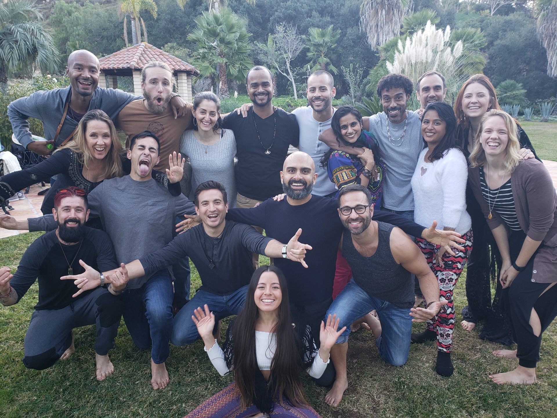 Improv Playground crew laughing together in a park at sunset