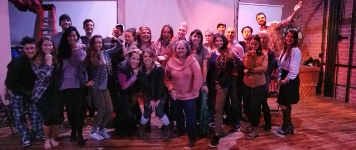 Wide shot of a warm, welcoming workshop group